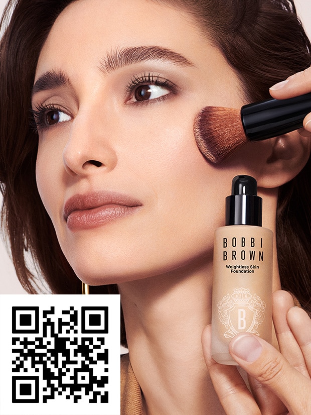 Model with foundation and foundation brush on face