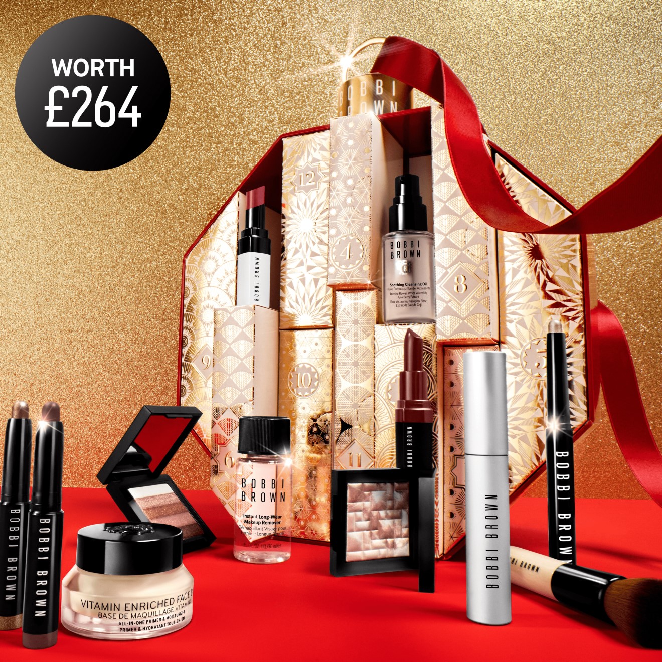 The 2023 Bobbi Brown Advent Calendar, revealing some of the product contents, decorated with a luxury red ribbon